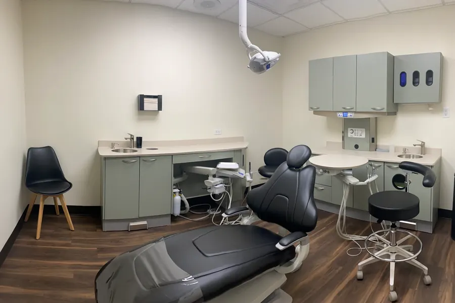 A treatment room at Charette Prosthodontics, with the dental chair and cabinetry.